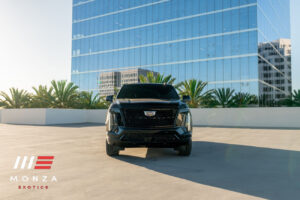 Black Cadillac Escalade ESV Platinum from Monza Exotics, front view on a rooftop