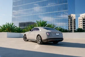 Tempest Grey Rolls-Royce Spectre from Monza Exotics parked on a rooftop in front of a glass office tower