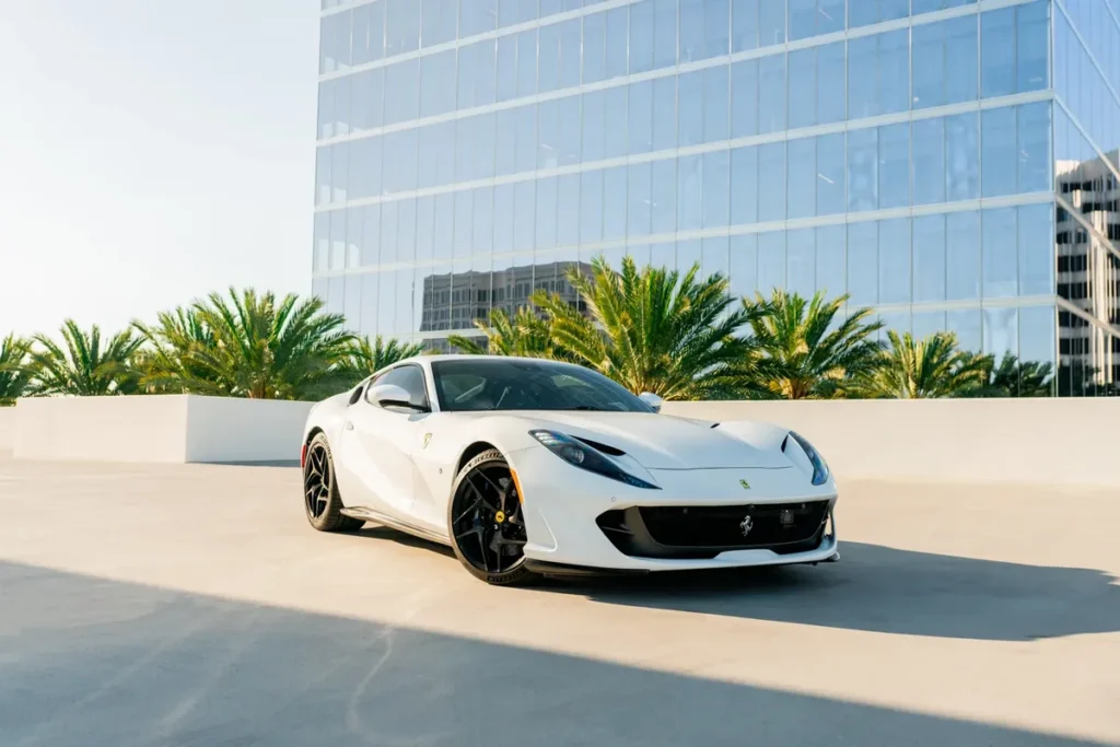 Front three quarter view of a white Ferrari 812 Superfast from Monza Exotics parked on a rooftop